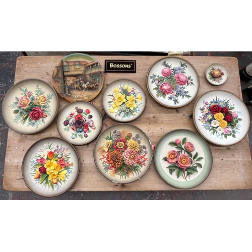 59 - Ten Bossons hand painted chalkware circular wall plaques to include The Arrival, Spring Flowers etc.