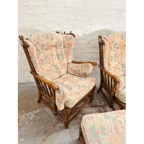 371 - An Ercol elm and floral upholstered four piece lounge suite comprising two seater sofa, two armchair... 