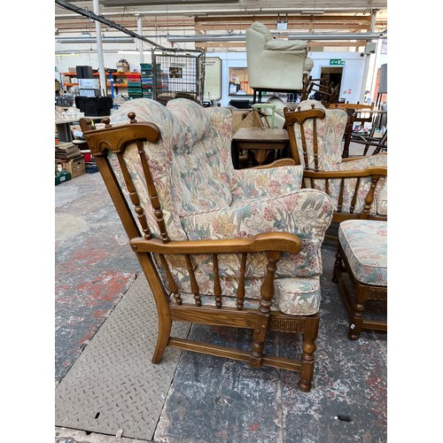 371 - An Ercol elm and floral upholstered four piece lounge suite comprising two seater sofa, two armchair... 