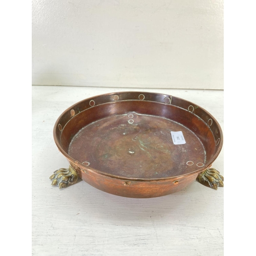 196 - Two items, one Victorian copper circular bowl with brass tri-footed supports - approx. 26cm in diame... 