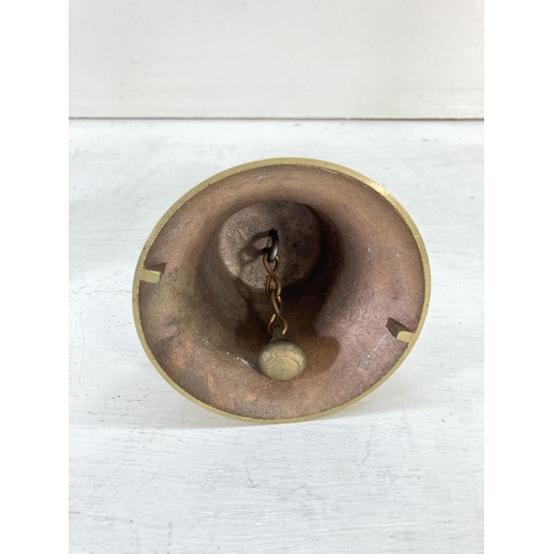 201 - Two vintage brass bells with wooden handles - largest approx. 27cm high