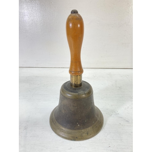 201 - Two vintage brass bells with wooden handles - largest approx. 27cm high