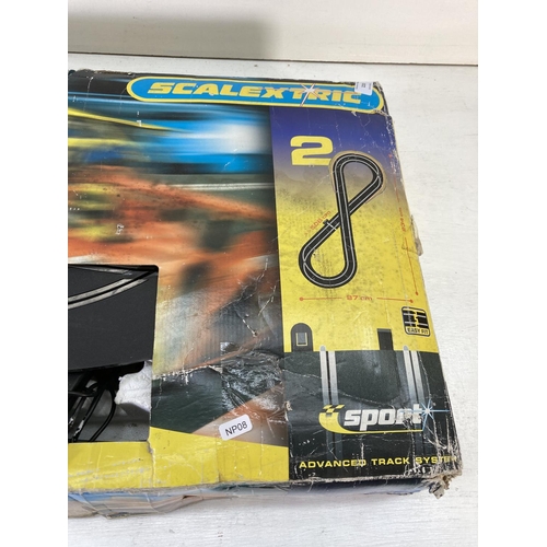 220 - A boxed Scalextric Speed Challenge slot car racing set comprising track, two vehicles, two remotes e... 