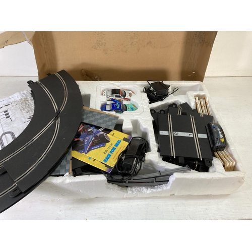 220 - A boxed Scalextric Speed Challenge slot car racing set comprising track, two vehicles, two remotes e... 