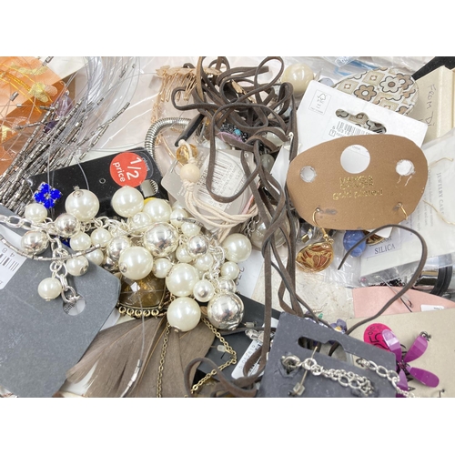 258 - A box containing a large quantity of assorted costume jewellery to include necklaces, cufflinks, Wal... 