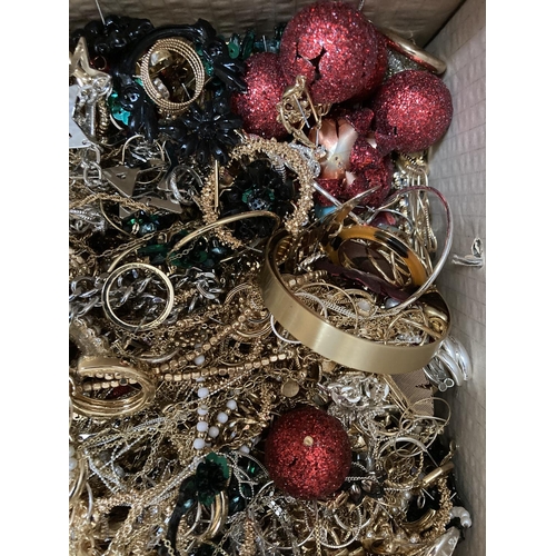 265 - A box containing a large quantity of assorted costume jewellery