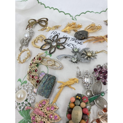 271 - Approx. 100 vintage brooches to include butterfly, filigree, panda etc.