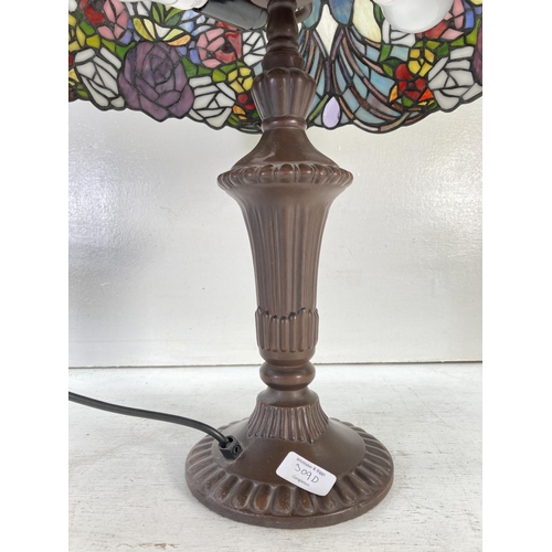 309D - A Tiffany style table lamp with butterfly and rose design - approx. 65cm high and shade approx. 40cm... 