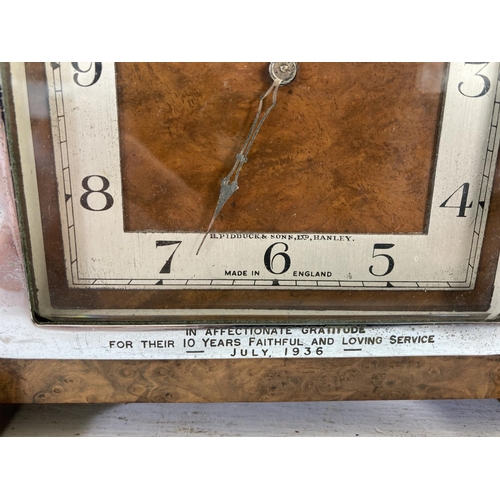 310 - An Art Deco H. Pidduck & Sons Ltd of Hanley burr walnut cased presentation clock - Presented to the ... 