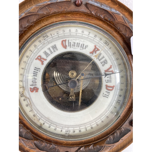 313 - A late 19th century carved walnut Aneroid barometer - approx. 21.5cm diameter