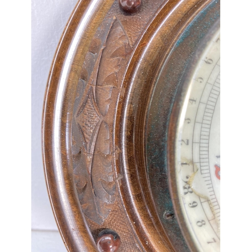 313 - A late 19th century carved walnut Aneroid barometer - approx. 21.5cm diameter