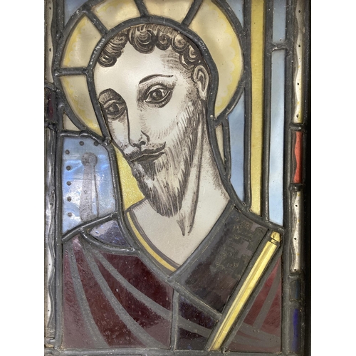 329 - An antique religious stained glass and hand painted panel in black painted pine frame - approx. 38.5... 