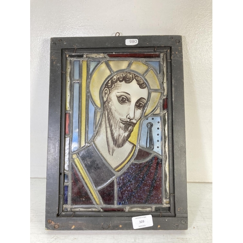 329 - An antique religious stained glass and hand painted panel in black painted pine frame - approx. 38.5... 