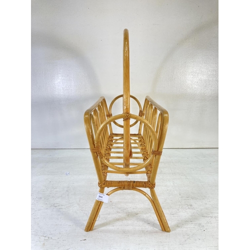 344 - A 1970s bamboo and cane magazine rack - approx. 57cm high x 47cm wide