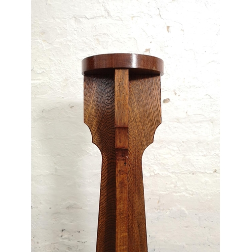 357 - A mid 20th century oak torchère with presentation plaque inscribed 'Presented by the Mayor of Congle... 