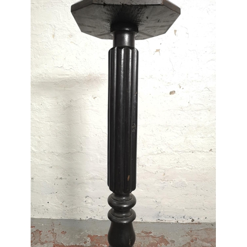 358 - A mid 20th century black painted reeded column torchère - approx. 98cm high