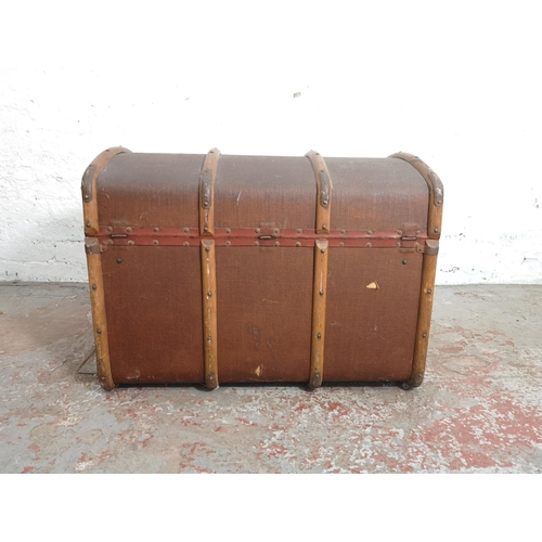 375 - An early 20th century wooden banded brown canvas travel trunk with contents - approx. 58cm high x 76... 