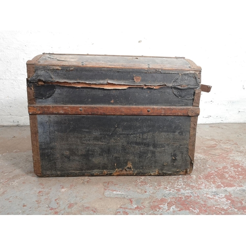 376 - A late 19th/early 20th century wooden and metal banded black canvas travel trunk - approx. 59cm high... 