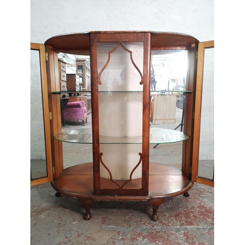 377 - A mid 20th century Art Deco style walnut bow fronted display cabinet with two glazed doors and two i... 