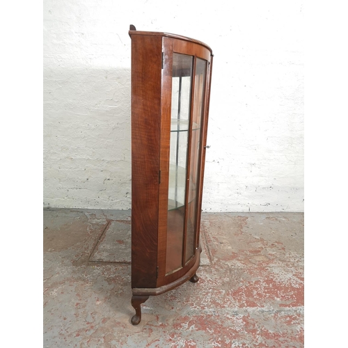 377 - A mid 20th century Art Deco style walnut bow fronted display cabinet with two glazed doors and two i... 