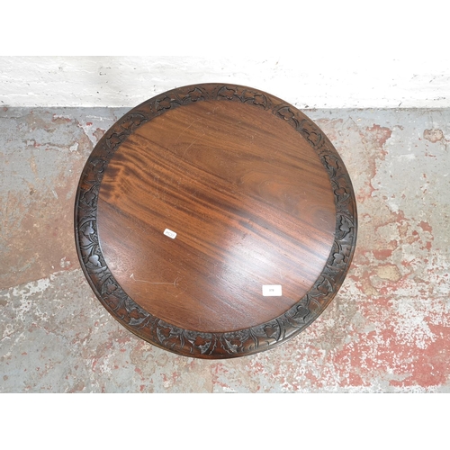 378 - A 19th century style mahogany circular top tripod pedestal side table with carved floral design and ... 