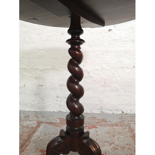 378 - A 19th century style mahogany circular top tripod pedestal side table with carved floral design and ... 