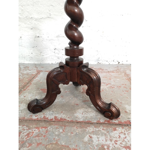 378 - A 19th century style mahogany circular top tripod pedestal side table with carved floral design and ... 