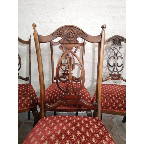 386 - A set of four Edwardian mahogany dining chairs with red upholstery