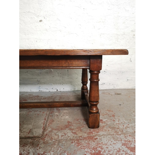 389 - A 17th century style solid oak rectangular coffee table with lower stretcher - approx. 49cm high x 6... 