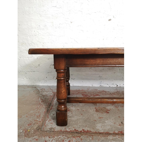 389 - A 17th century style solid oak rectangular coffee table with lower stretcher - approx. 49cm high x 6... 