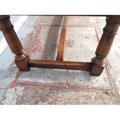 389 - A 17th century style solid oak rectangular coffee table with lower stretcher - approx. 49cm high x 6... 