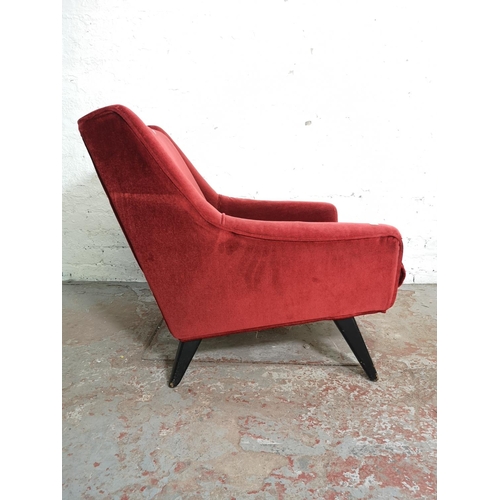 393 - A mid 20th century G Plan red upholstered armchair with ebonised splayed supports - approx. 74cm hig... 