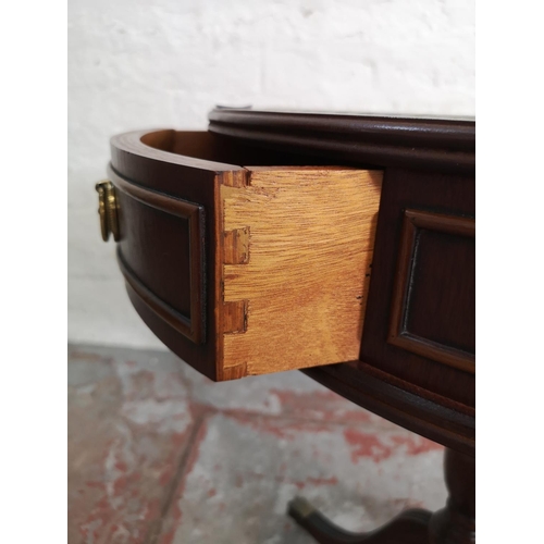 402 - A Regency style mahogany drum table with green leather insert and brass lion paw feet - approx. 59cm... 