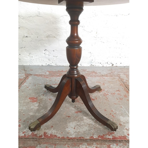 402 - A Regency style mahogany drum table with green leather insert and brass lion paw feet - approx. 59cm... 