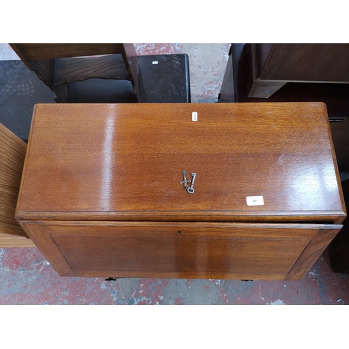 407 - A mid 20th century oak bureau with three drawers, fall front and baluster supports - approx. 101cm h... 