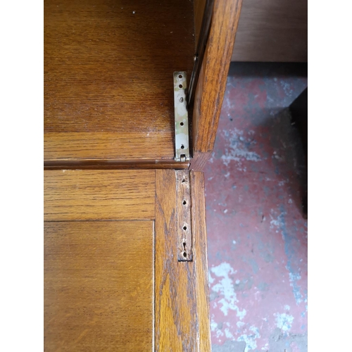 407 - A mid 20th century oak bureau with three drawers, fall front and baluster supports - approx. 101cm h... 