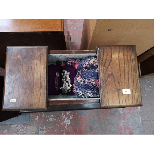 409 - Two pieces of mid 20th century oak furniture, one sewing box - approx. 58cm high x 41cm wide x 31cm ... 