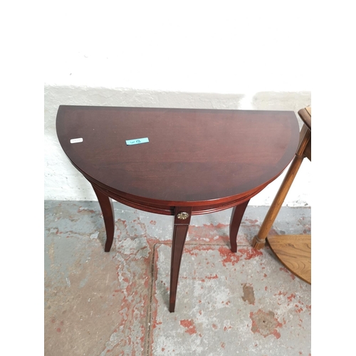 411 - Two half moon console tables, one Ercol elm two tier approx. 72cm high x 65cm wide x 33cm deep and o... 