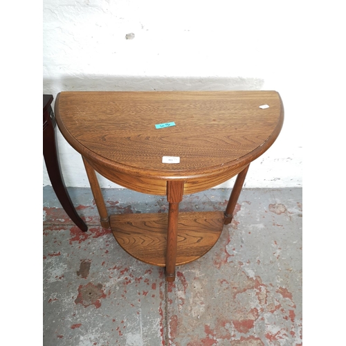 411 - Two half moon console tables, one Ercol elm two tier approx. 72cm high x 65cm wide x 33cm deep and o... 