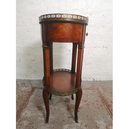 412 - A Regency style mahogany two tier oval side table with brown leatherette inserts and brass galleried... 