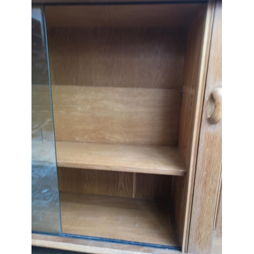 420 - A mid 20th century light oak bookcase with two glass sliding doors, two internal shelves and single ... 