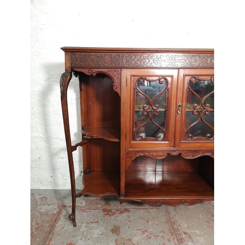 427 - A late Victorian/Edwardian mahogany display cabinet with two central glazed doors, four outer shelve... 