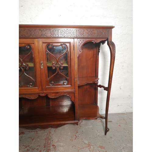 427 - A late Victorian/Edwardian mahogany display cabinet with two central glazed doors, four outer shelve... 