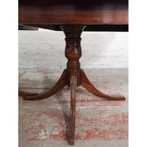 431 - A 19th century style simulated rosewood twin pedestal extending dining table