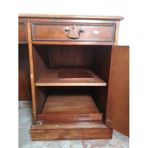 434 - A 19th century style mahogany pedestal desk with five drawers, green leather insert and brass swan n... 