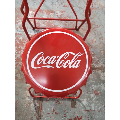 435 - A Coca-Cola red metal folding advertising bistro set with bottle cap design - table approx. 105cm hi... 