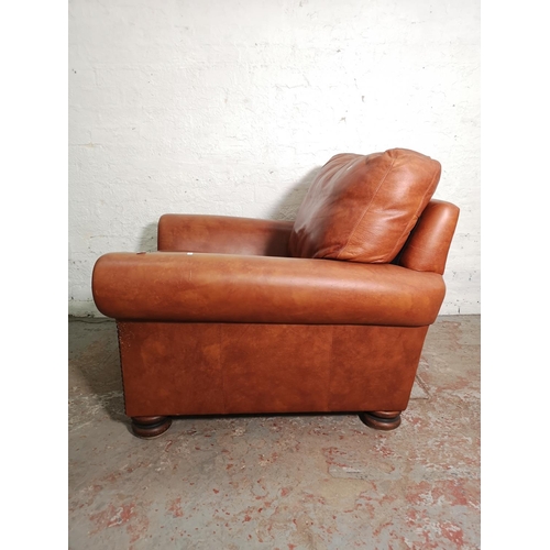 439 - A Marks & Spencer tan leather and brass studded armchair - approx. 74cm high x 98cm wide x 89cm deep