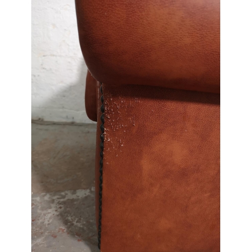 439 - A Marks & Spencer tan leather and brass studded armchair - approx. 74cm high x 98cm wide x 89cm deep