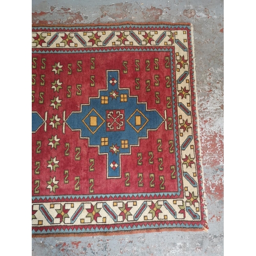 441A - A Persian style red rug - approx. 183cm x 133cm