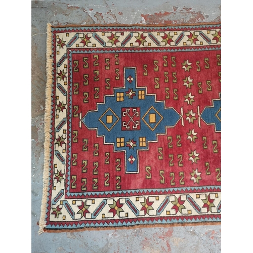 441A - A Persian style red rug - approx. 183cm x 133cm